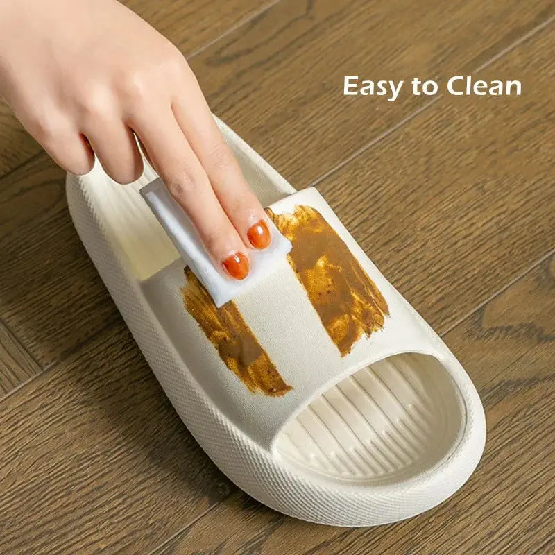 A hand wipes a CozySteps Unisex EVA Beach & Bathroom Flip-Flop (CozySteps.uk, US 6–12) with a sponge, removing a brown stain on a wooden floor. “Easy to Clean” highlights its quick-dry and non-slip sole features in the top right corner.